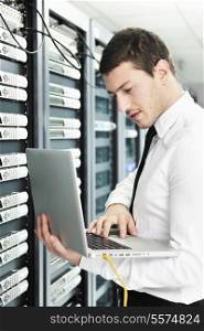 young it engeneer business man with thin modern aluminium laptop in network server room