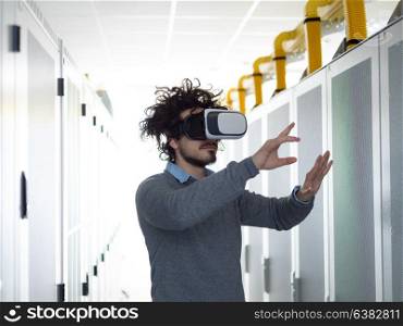 young IT engeneer using virtual reality headset over server room background