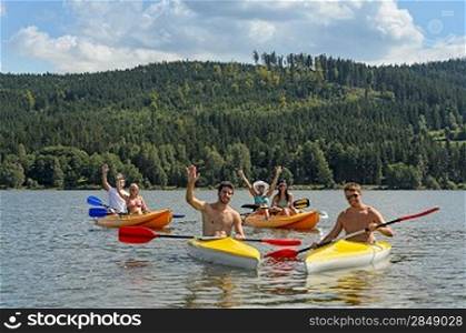Young kayaking friends having fun in scenic view summer holiday