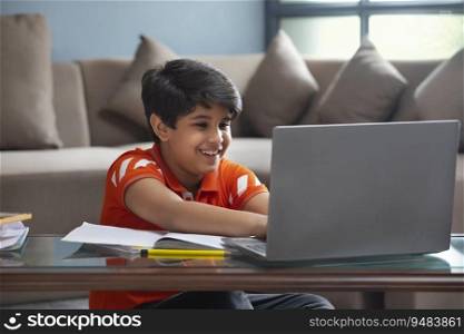 YOUNG KID ATTENDING HIS ONLINE CLASS IN ENTHUSIASM