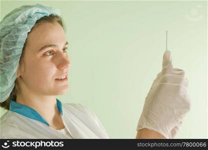 Young lady doctor with syringe