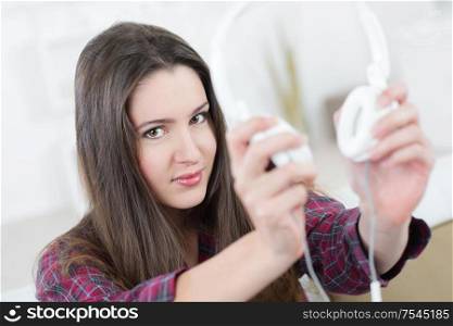 young lady holding headphones in front of her
