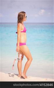 Young Lady Holding Snorkel Gear in Hands on The Tropical Beach