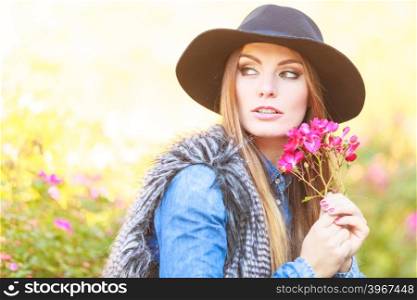 Young lady relaxing in garden. Relax and gardening. Lovely cute young woman spending time in garden. Beauty girl with pink flowers outdoor.