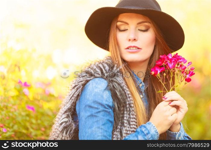 Young lady relaxing in garden. Relax and gardening. Lovely cute young woman spending time in garden. Beauty girl with pink flowers outdoor.