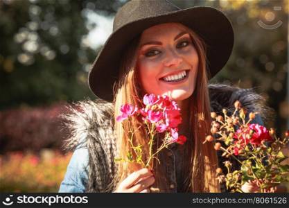 Young lady relaxing in garden. Relax and gardening. Lovely cute young woman spending time in garden. Cheerful beauty girl with pink flowers outdoor.
