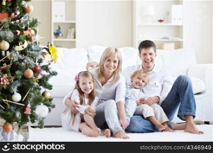Young laughing family home with spruce
