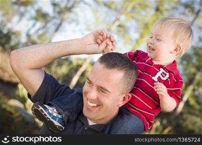 Young Laughing Father and Child Having Piggy Back Fun.