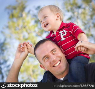 Young Laughing Father and Child Having Piggy Back Fun.. Young Laughing Father and Child Having Piggy Back Fun.