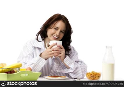 young laughing woman at breakfast. young laughing woman holding coffee mug at breakfast