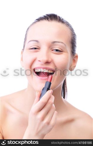 young laughing woman is applying cosmetics on her face and looking at camera, isolated on white