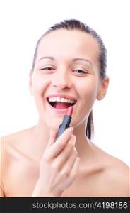 young laughing woman is applying cosmetics on her face and looking at camera, isolated on white