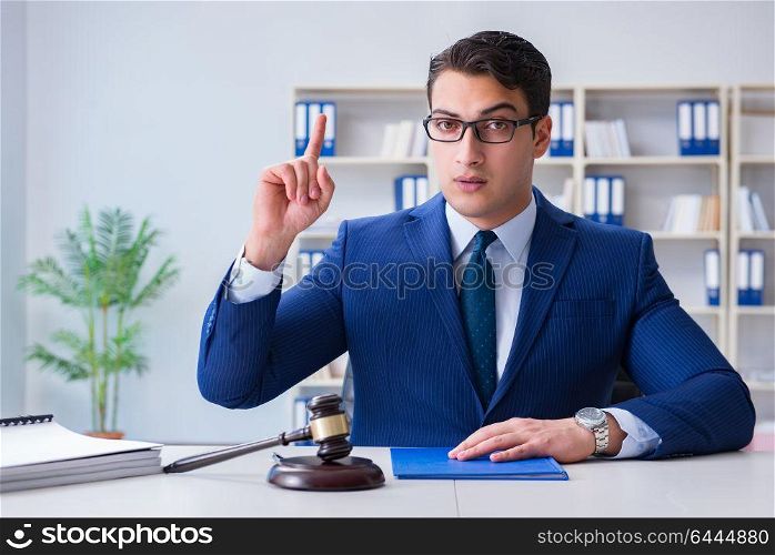 Young lawyer judge sitting in the office