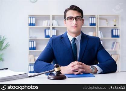 Young lawyer judge sitting in the office