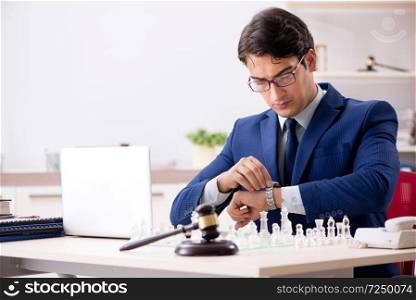 Young lawyer playing chess to train his court strategy and tactics. Young lawyer playing chess to train his court strategy and tacti