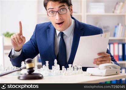 Young lawyer playing chess to train his court strategy and tactics. Young lawyer playing chess to train his court strategy and tacti