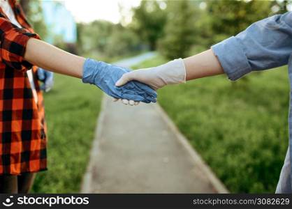 Young love couple in gloves walks in park, quarantine. Romantic meeting during the epidemic, health care and protection, pandemic lifestyle. Love couple in gloves walks in park, quarantine