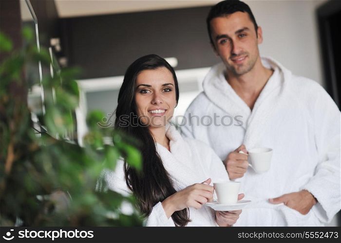 Young love couple taking fresh morning cup of coffee in the modern appartment