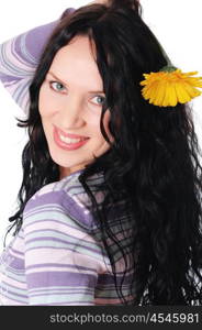 Young lovely brunette playing with a yellow flower isolated on white