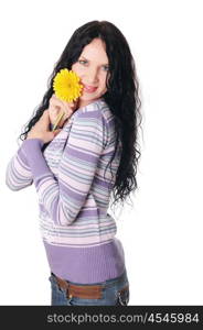 Young lovely brunette playing with a yellow flower isolated on white