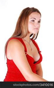 Young, lovely girl in a nice red dress and diamond necklace, looking awayfrom the camera, sitting in the studio for white background.