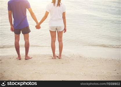 Young lover couple enjoying vacation on the beach together.
