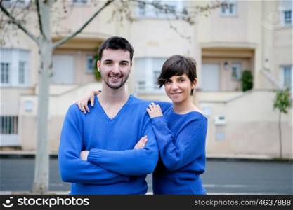 Young lovers dressed in blue excited about your new home