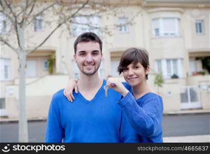 Young lovers dressed in blue excited about your new home