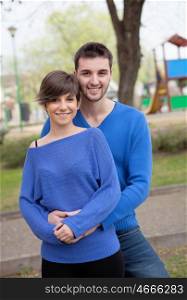 Young lovers dressed in blue looking at camera
