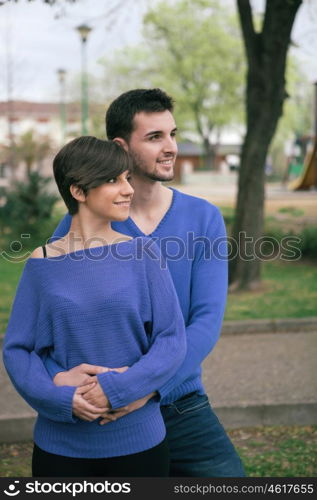 Young lovers dressed in blue looking at side