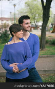 Young lovers dressed in blue looking at side