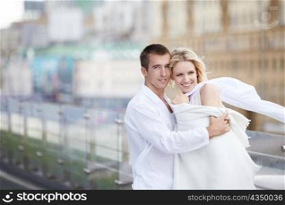 Young lovers in white on the roof