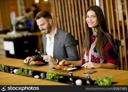 Young loving couple having lunch in the modern restaurant