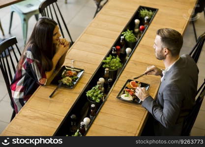 Young loving couple having lunch in the modern restaurant