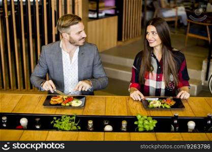 Young loving couple having lunch in the modern restaurant