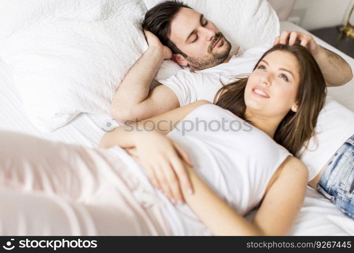 Young loving couple in bed