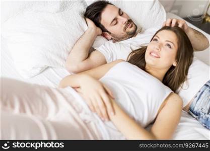 Young loving couple in bed
