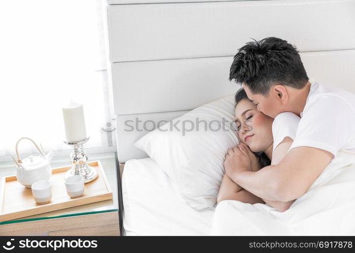 Young loving couple in the bed. Modern lifestyle concept