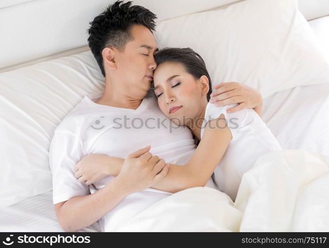 Young loving couple in the bed. Modern lifestyle concept