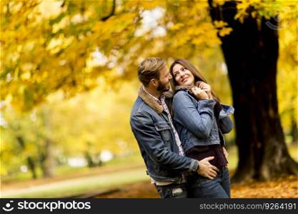 Young loving couple in the park on a sunny autumn day