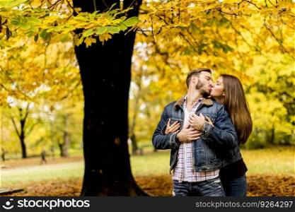 Young loving couple in the park on a sunny autumn day