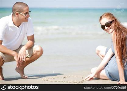 Young loving Couple siting on the beach