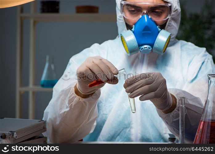 Young make scientist working with dangerous hazardous substances