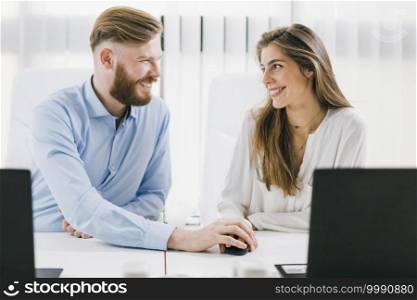 Young male and female colleagues having a romantic affair at Work. Workplace Relationship.. Workplace Relationship Romance