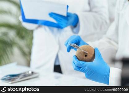 Young male archaeologist measuring ancient artifacts in laboratory.. Archeology Scientists Measuring Prehistoric Artefact with Digital Caliper in Laboratory