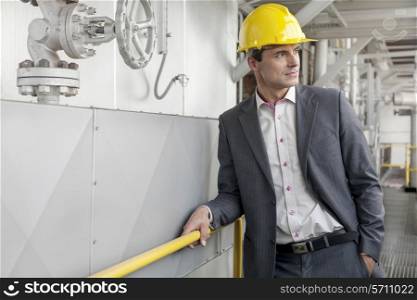 Young male architect in hand hat at industry