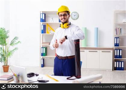 Young male architect working in the office 