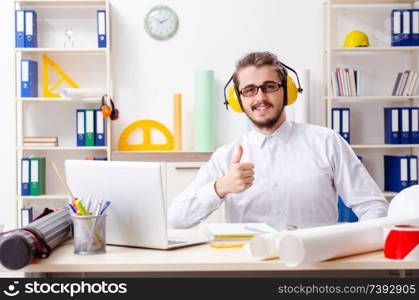 Young male architect working in the office 