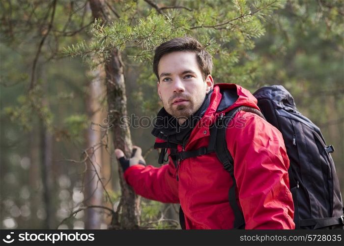 Young male backpacker in forest