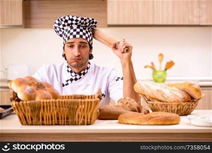 Young male baker working in kitchen 